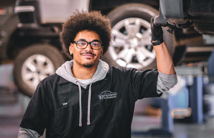 Woman and man working on a car