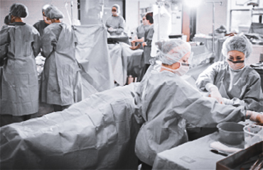 Several people in a mock surgery lab