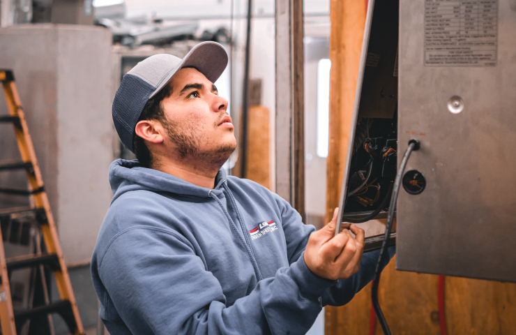 Woman working in electrical panel