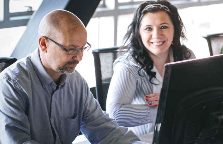 Man and woman working on a computer