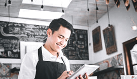 Man in restaurant looking at notepad