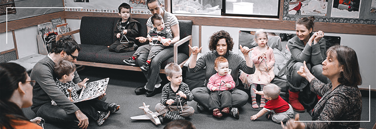 Children and Parents sitting onthe floor in class