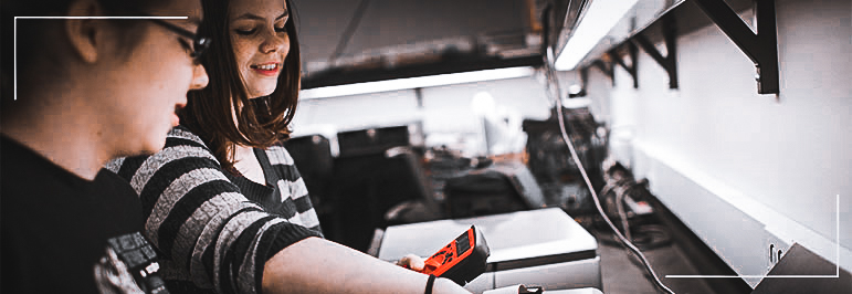 Two women using a multimeter