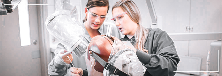 Dental student and teacher working with patient